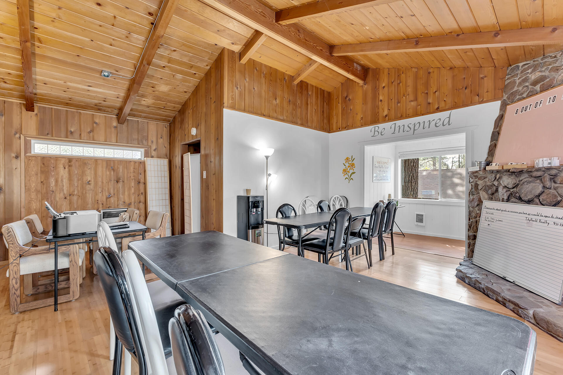 54585 North Circle Drive Idyllwild, CA 92549 - Photo 23 of 58 a dining room with furniture floor to ceiling windows and wooden floor