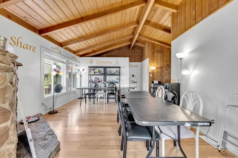 a dinning table sitting in a kitchen next to a window
