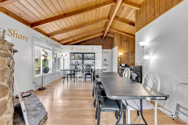 a dinning table sitting in a kitchen next to a window