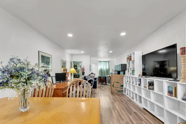 a very nice looking living room with dining room and wooden floor