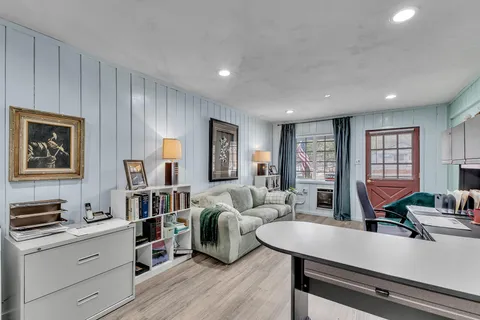 a living room with furniture a fireplace and a large window