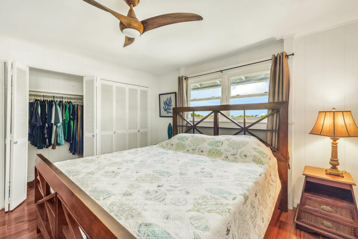 3567 Waha Road Kalaheo, HI 96741 - Photo 12 of 25 a bedroom with a bed and a dresser with mirror