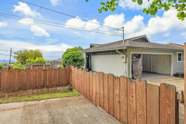 a view of a house with wooden fence