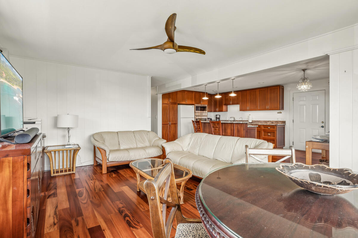 3567 Waha Road Kalaheo, HI 96741 - Photo 6 of 25 a living room with couches chairs and kitchen view with wooden floor