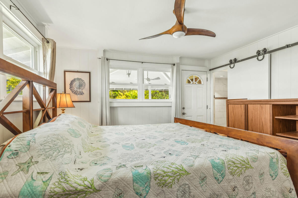 3567 Waha Road Kalaheo, HI 96741 - Photo 9 of 25 a large bedroom with a bed and a chandelier