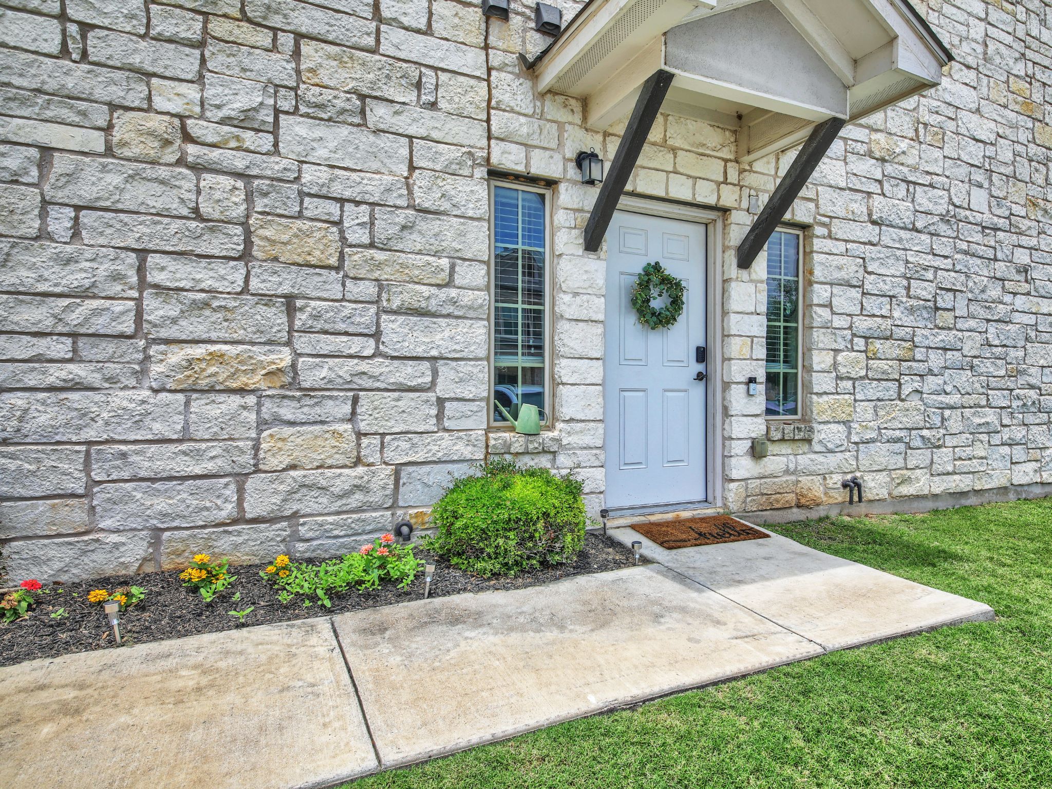 1600 Airedale Road, Unit 2601 Austin, TX 78748 - Photo 3 of 26 A welcoming stone-clad facade with a clean walkway and cheerful landscaping.