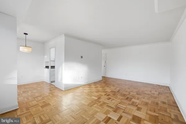 a view of empty room with wooden floor