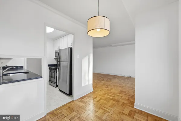 a kitchen with refrigerator and microwave