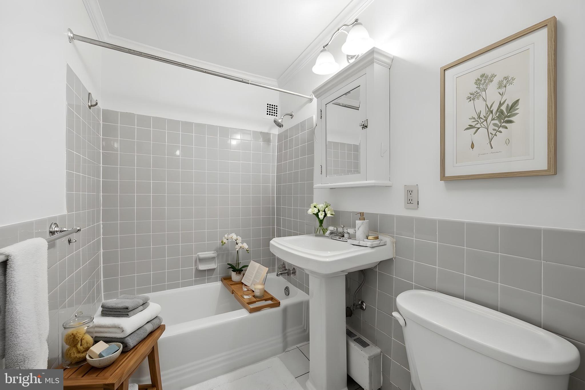 4000 Tunlaw Road Northwest, Unit 220 Washington, DC 20007 - Photo 22 of 30 a bathroom with a sink toilet and shower