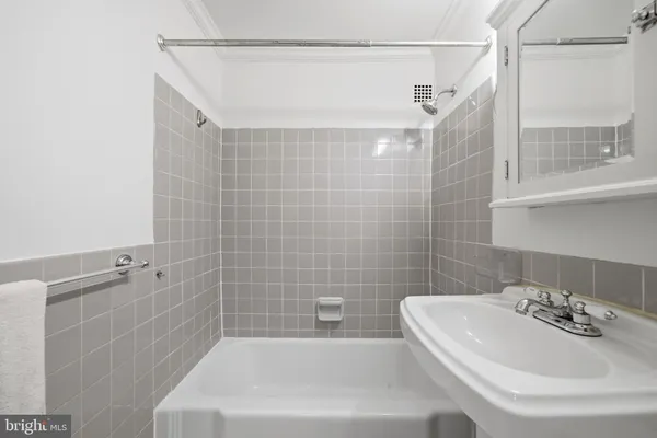 a bathroom with a sink a bathtub and shower