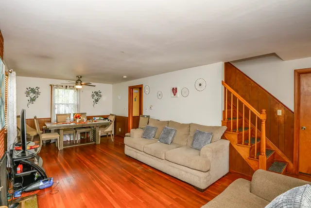 a living room with furniture and wooden floor