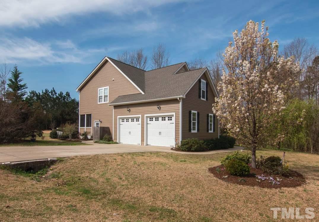 2420 Rolling Tracks Road Willow Spring, NC 27592 - Photo 3 of 25 a front view of a house with a yard and garage