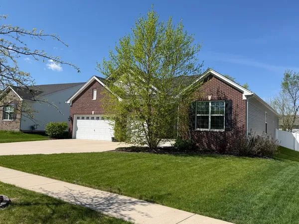 a front view of house with yard and green space