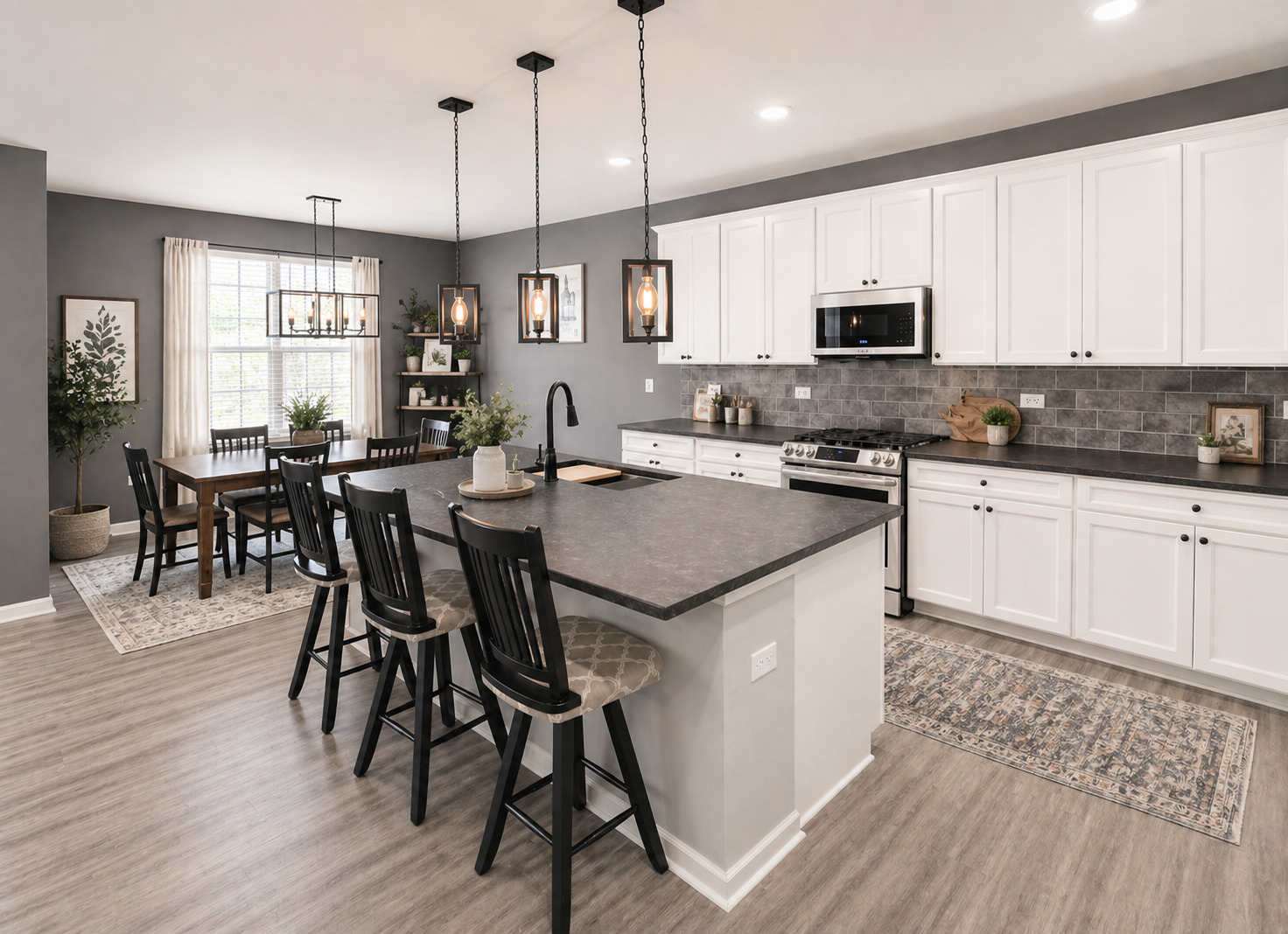 713 Long Ridge Trail Minooka, IL 60447 - Photo 16 of 40 a kitchen with stainless steel appliances granite countertop a stove top oven a sink a dining table and chairs with wooden floor