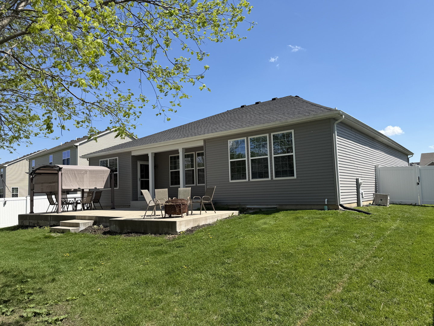 713 Long Ridge Trail Minooka, IL 60447 - Photo 38 of 40 a front view of a house with a garden and sitting area