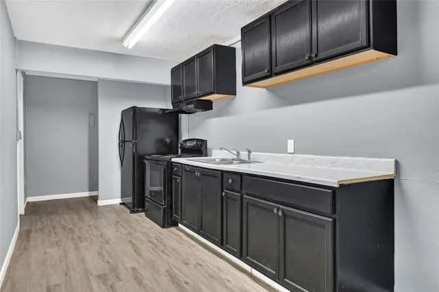 a kitchen with refrigerator cabinets and wooden floor