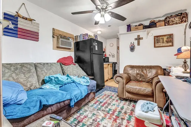 a living room with furniture ceiling fan and a rug