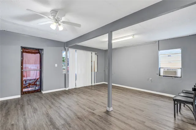a view of an empty room with wooden floor