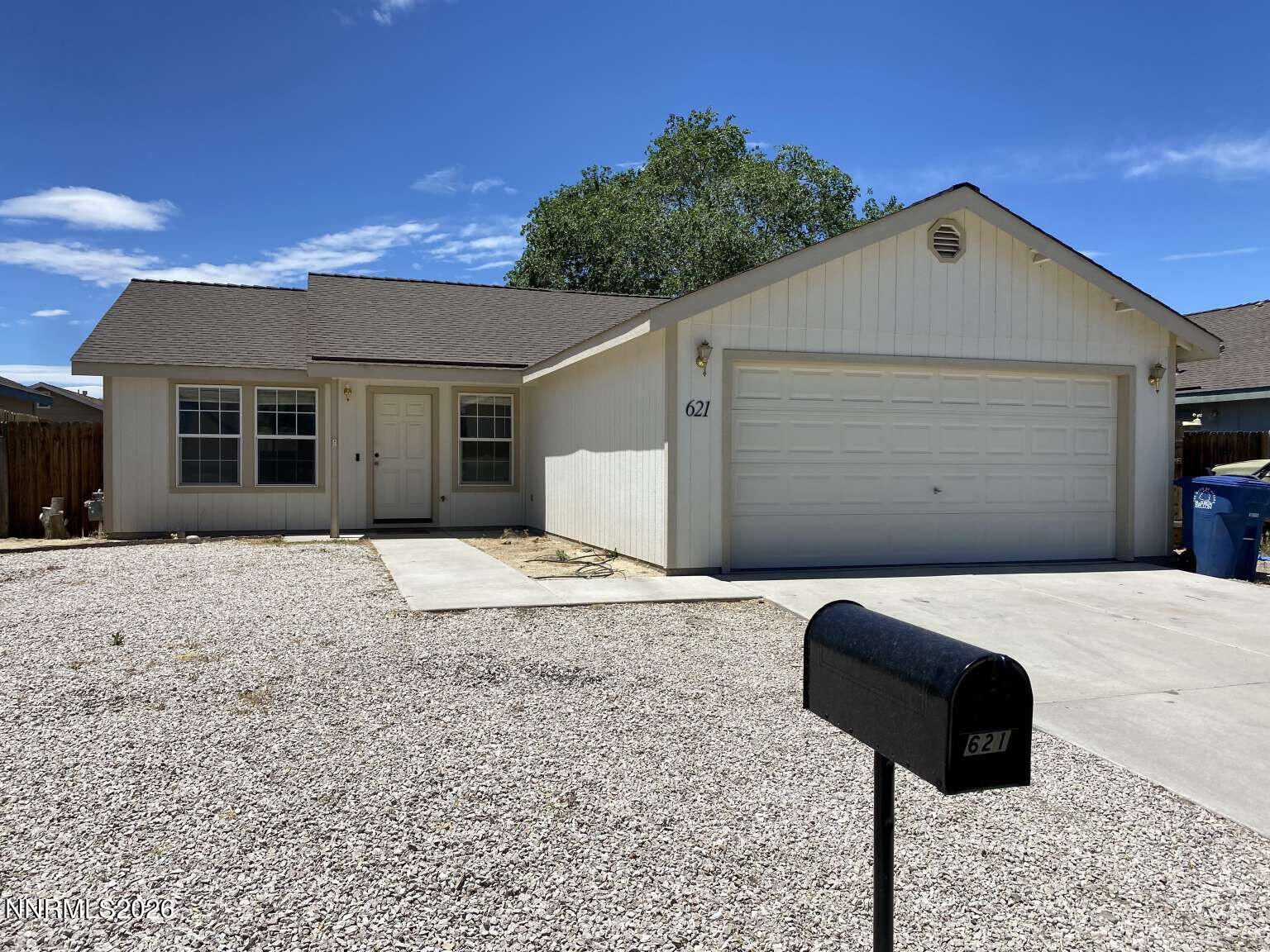 621 Keppel Street Fallon, NV 89406 - Photo 1 of 15 a front view of a house with a garage