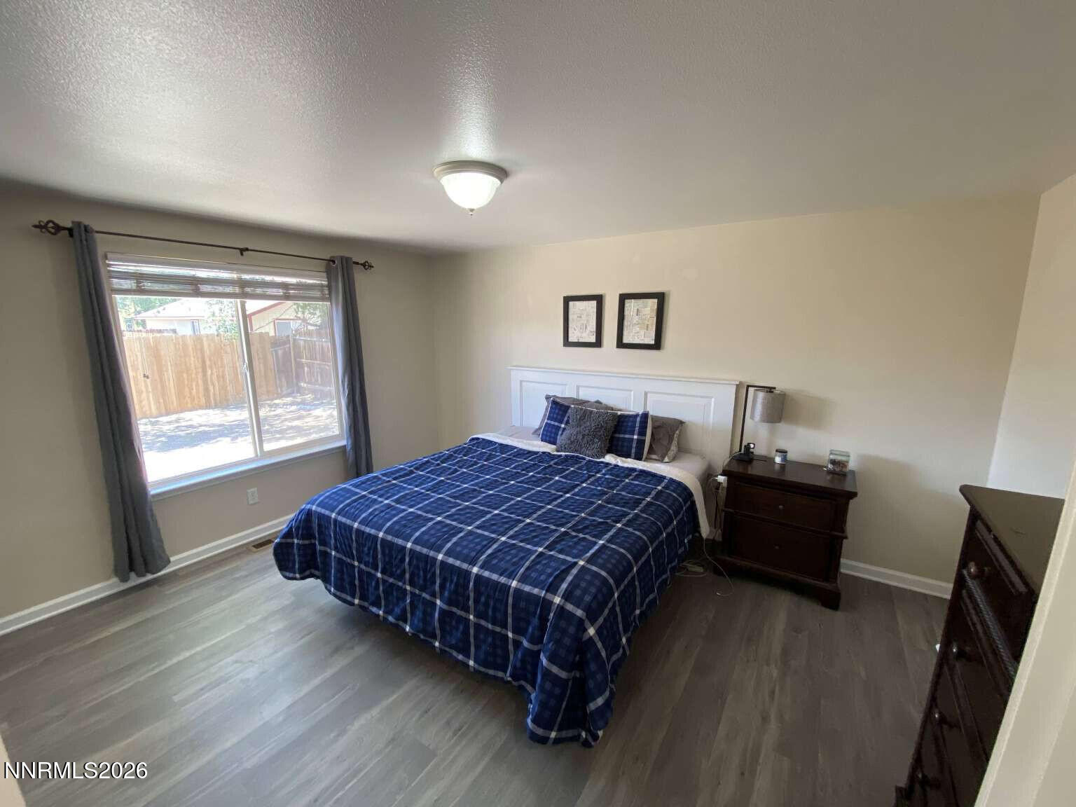 621 Keppel Street Fallon, NV 89406 - Photo 12 of 15 a bedroom with a bed and wooden floor