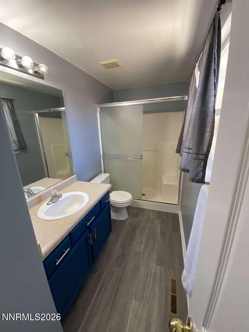 621 Keppel Street Fallon, NV 89406 - Photo 10 of 15 a bathroom with a sink a toilet a mirror and vanity