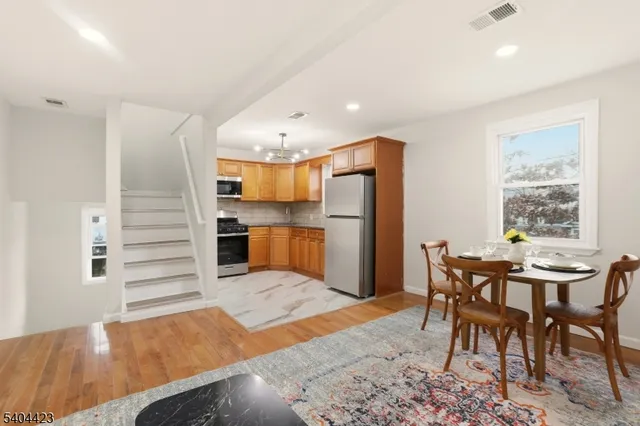 a view of a dining room with furniture and a window