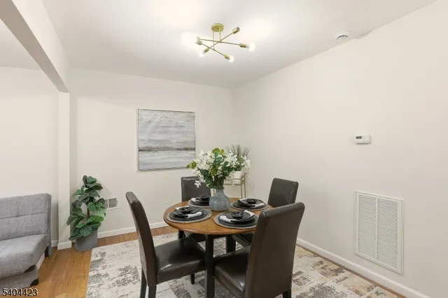 a dining room with furniture and wooden floor