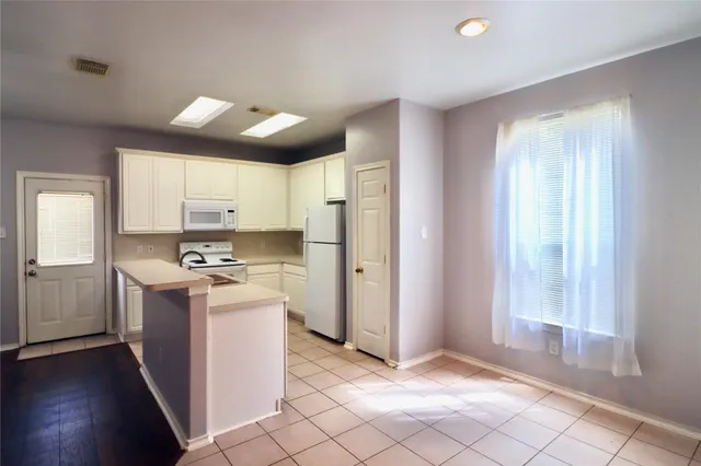a kitchen with stainless steel appliances granite countertop a stove and a refrigerator