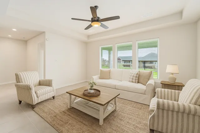 a living room with furniture and a large window