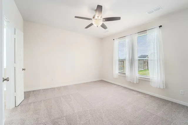 a bedroom with bed and window