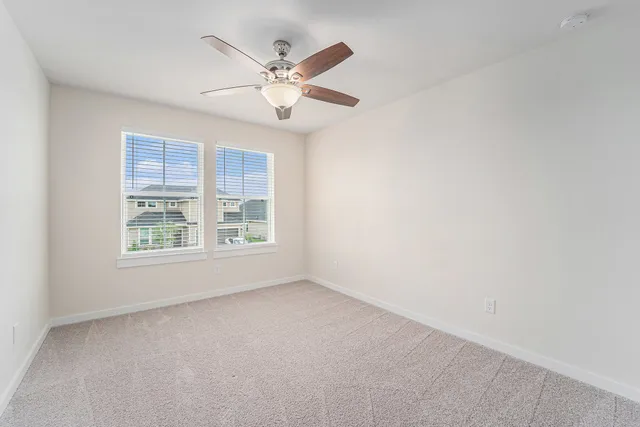 a bedroom with a bed and a table in it with window