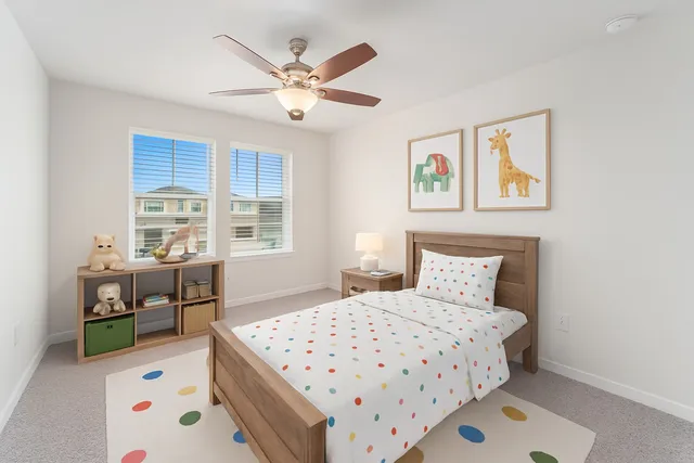 an empty room with a window and a ceiling fan