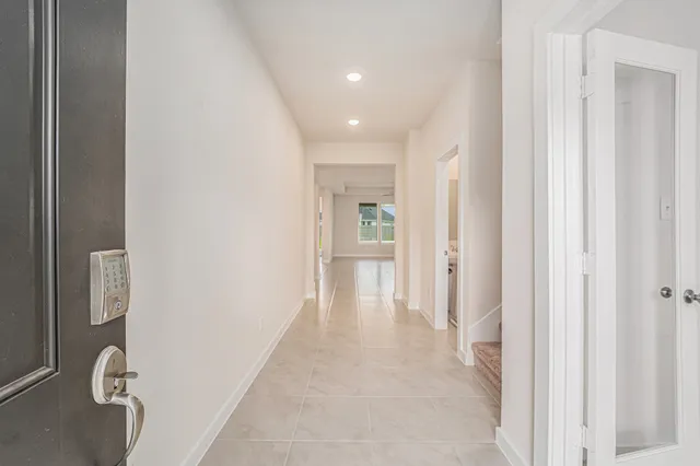 a view of a hallway with wooden shelves