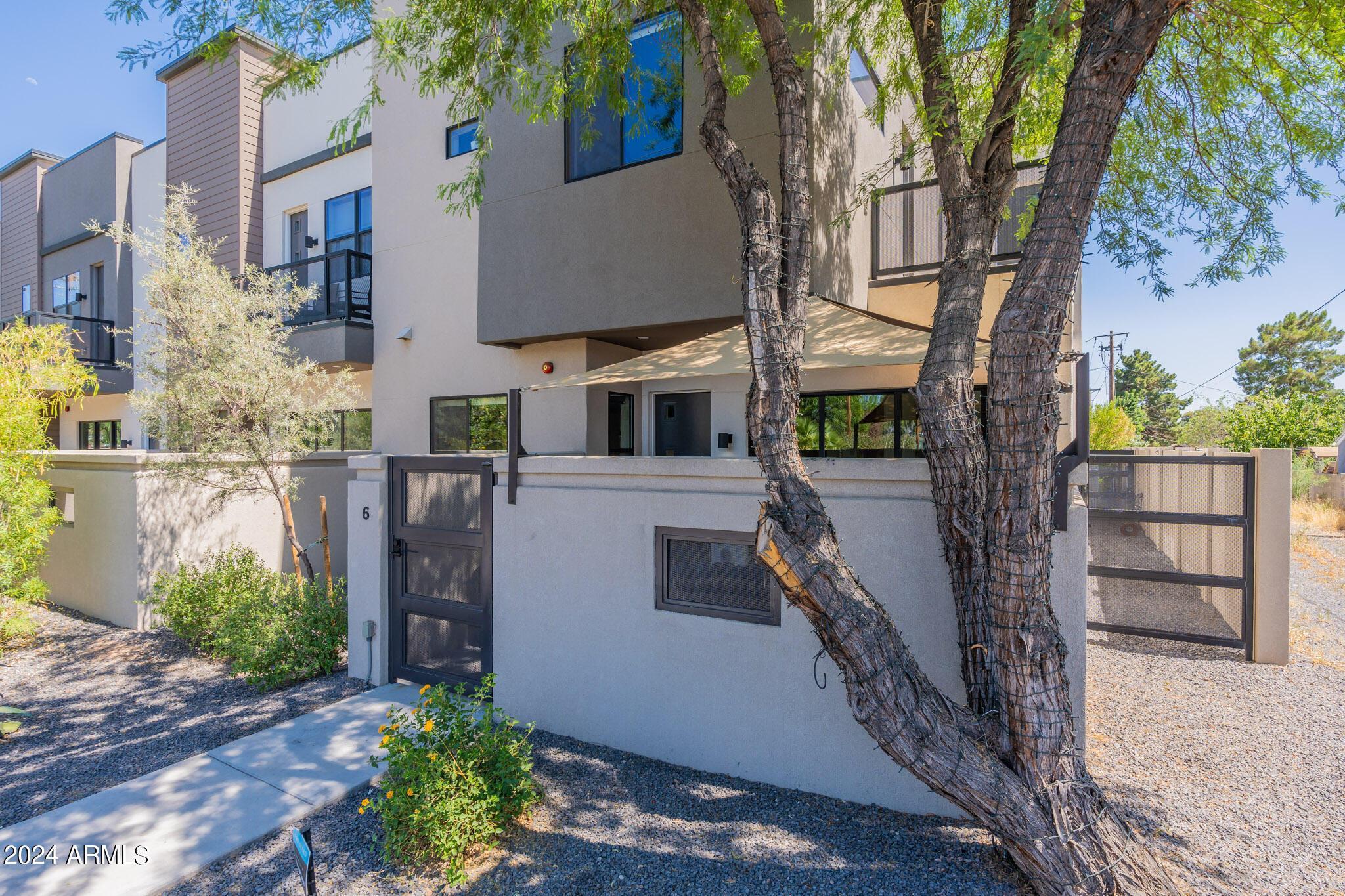 2645 East Osborn Road, Unit 6 Phoenix, AZ 85016 - Photo 2 of 4 a front view of a house with a yard