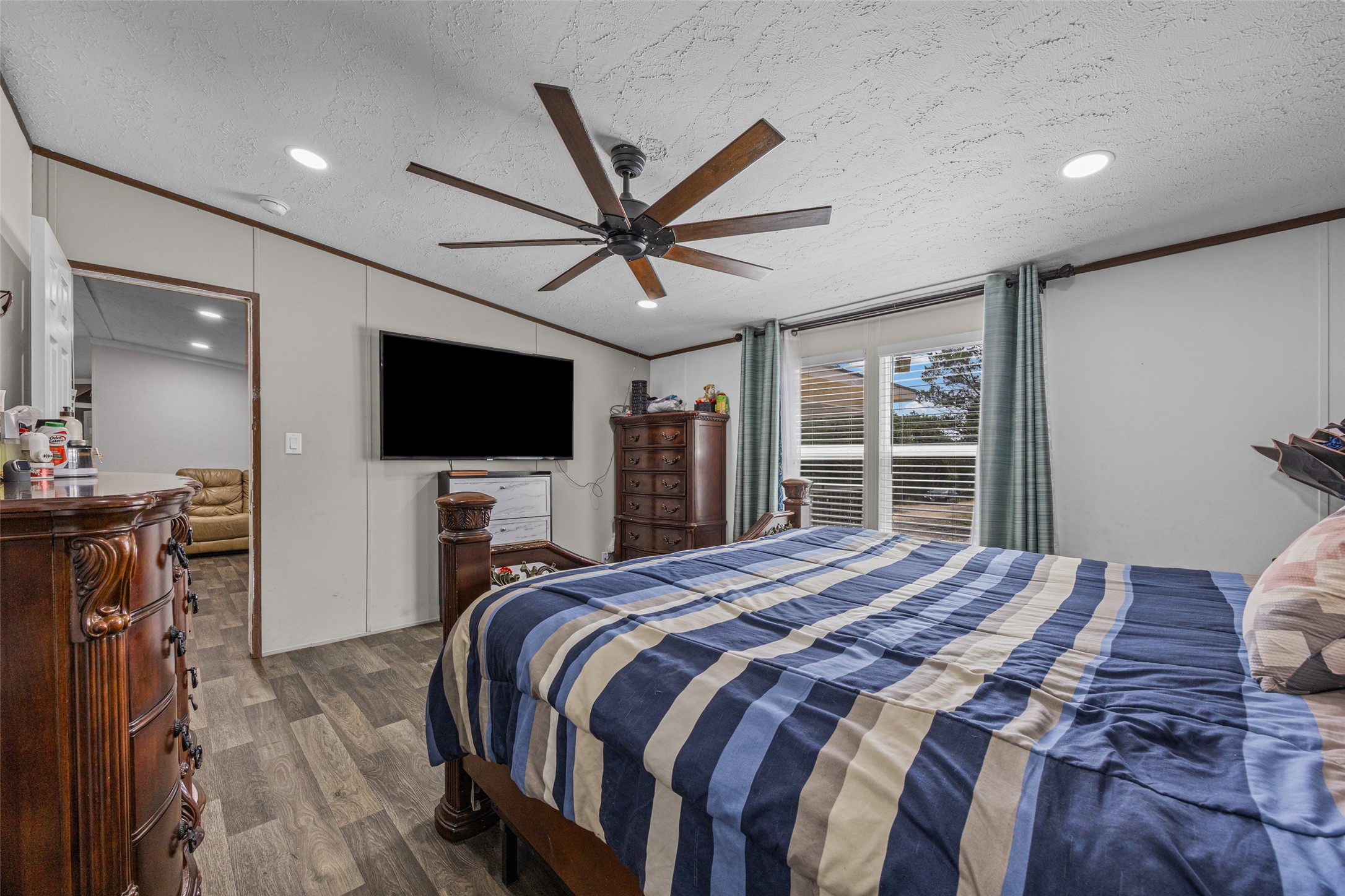 564 Boyd Road Red Rock, TX 78662 - Photo 15 of 25 A naturally illuminated bedroom offers wood-like flooring and recessed lighting.
