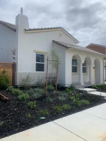 a front view of a house with garden