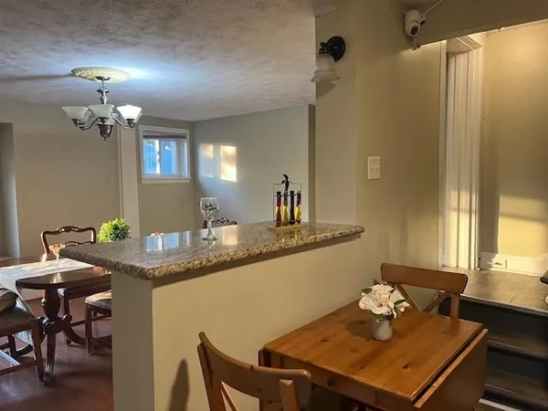 a kitchen with stainless steel appliances granite countertop a stove top oven a sink and a refrigerator