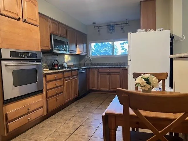 a kitchen with a refrigerator a stove and a refrigerator