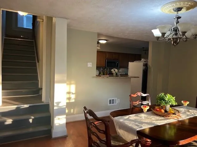 a view of a dining room with furniture and chandelier