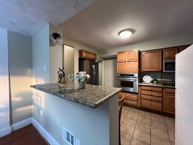 5582 Pocusset Street Pittsburgh, PA 15217 - Photo 10 of 29 a kitchen with stainless steel appliances granite countertop a sink dishwasher stove and refrigerator
