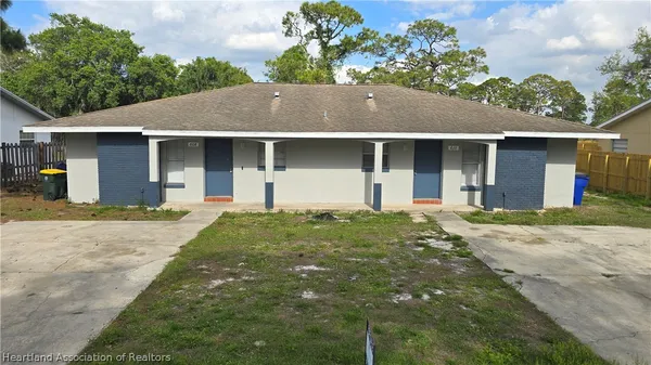 a front view of house with yard and trees