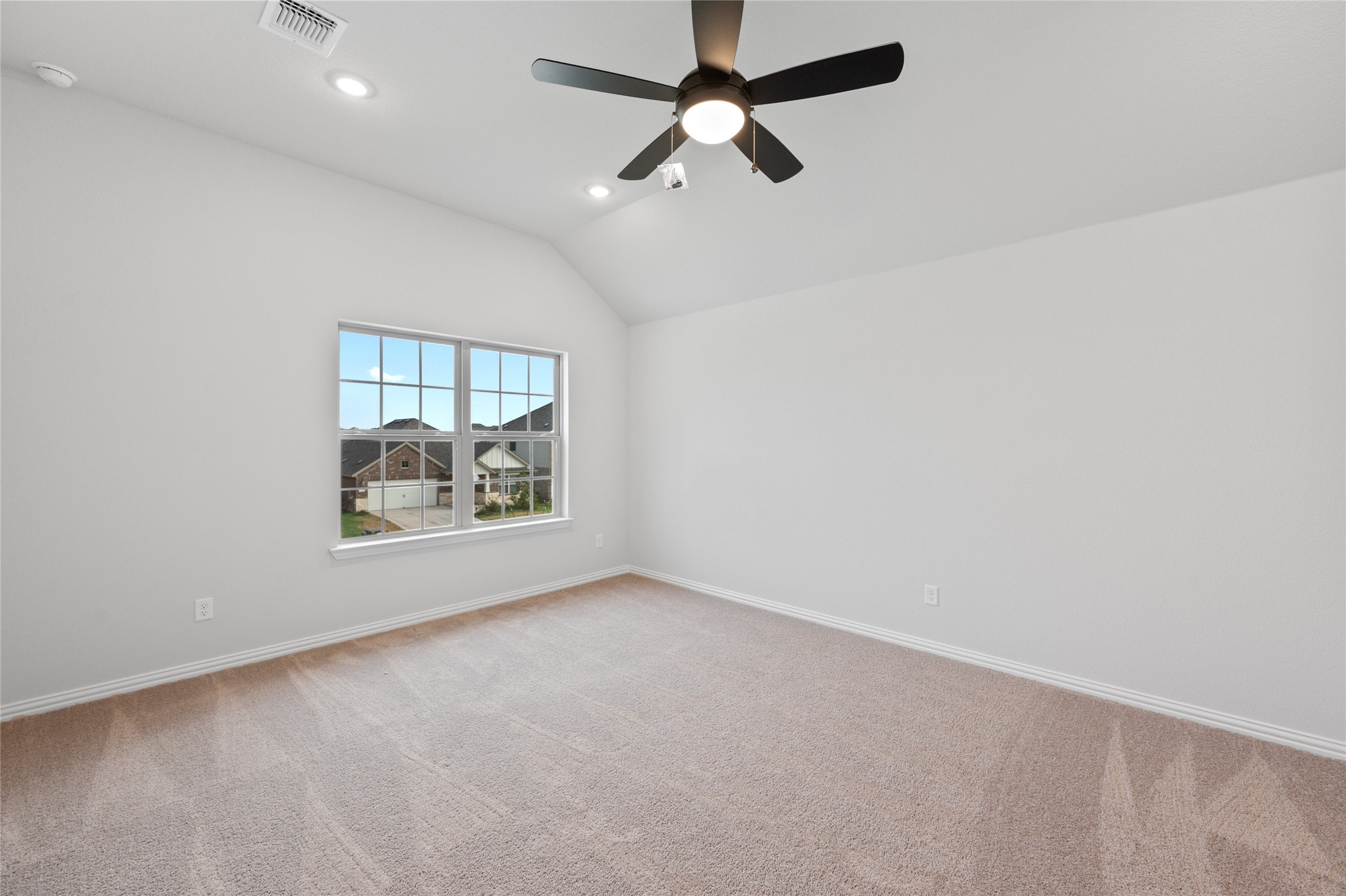 303 Fawn Riv Run Kyle, TX 78640 - Photo 14 of 32 Carpeted room featuring a vaulted ceiling with recessed lighting and a black ceiling fan, multiple pane window, and white baseboards