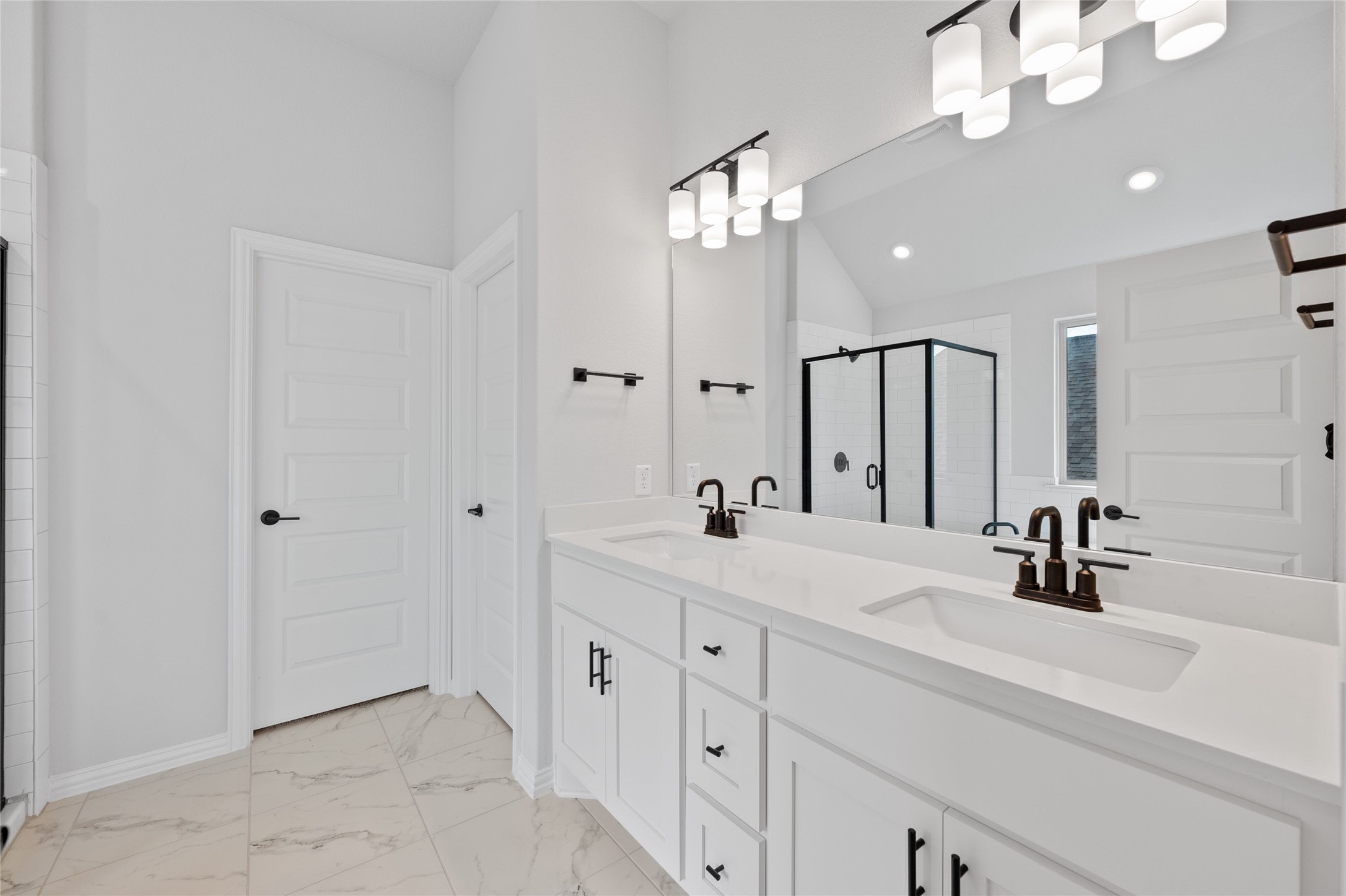 303 Fawn Riv Run Kyle, TX 78640 - Photo 17 of 32 Dual vanity with white cabinetry and integrated sinks