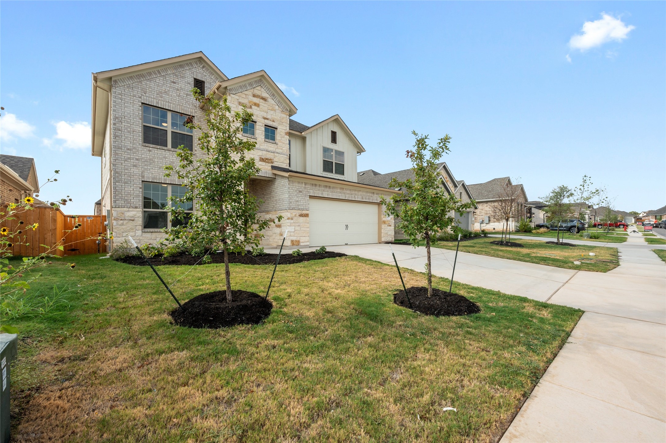 303 Fawn Riv Run Kyle, TX 78640 - Photo 2 of 32 Two-story residence featuring a combination of light-colored brick and stone veneer