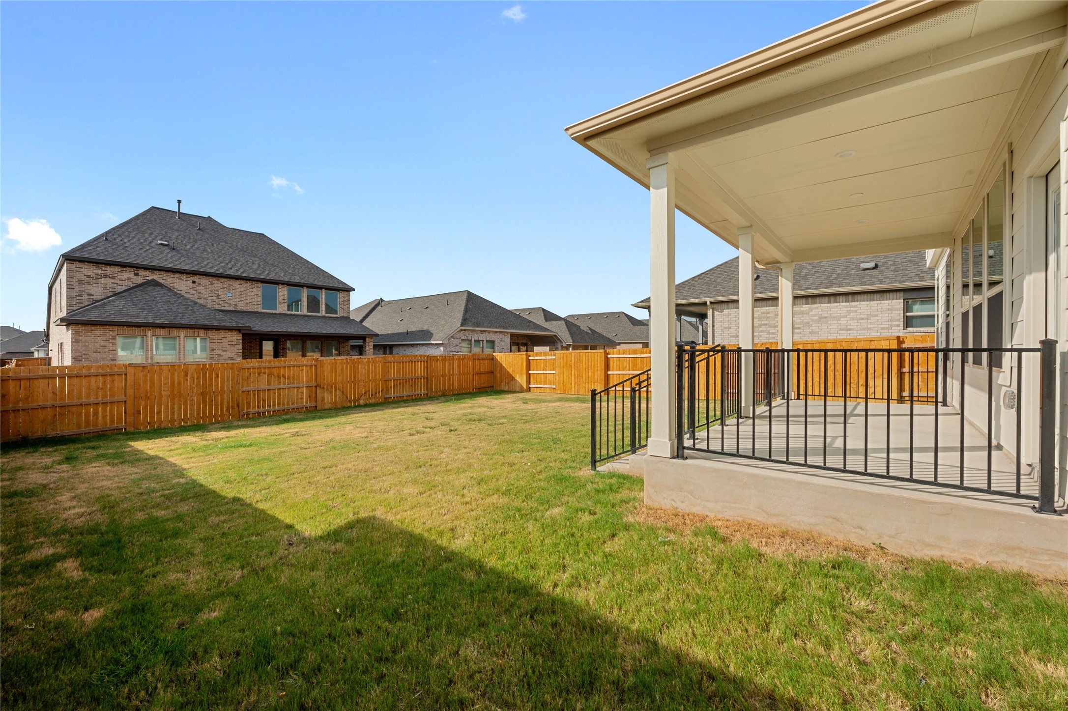 303 Fawn Riv Run Kyle, TX 78640 - Photo 29 of 32 Covered patio featuring concrete flooring and black metal railings