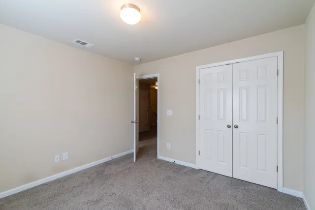 an empty room with closet area