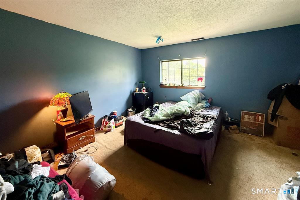 817 Woodtick Road, Unit A Waterbury, CT 06705 - Photo 11 of 16 a living room with furniture and a window
