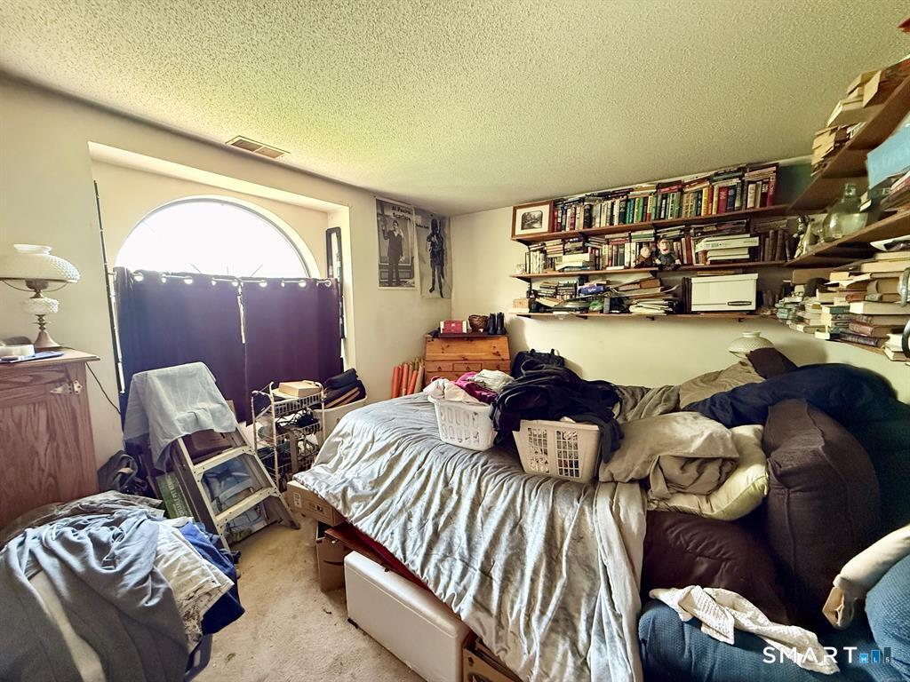 817 Woodtick Road, Unit A Waterbury, CT 06705 - Photo 13 of 16 a bedroom with furniture and a wooden floor