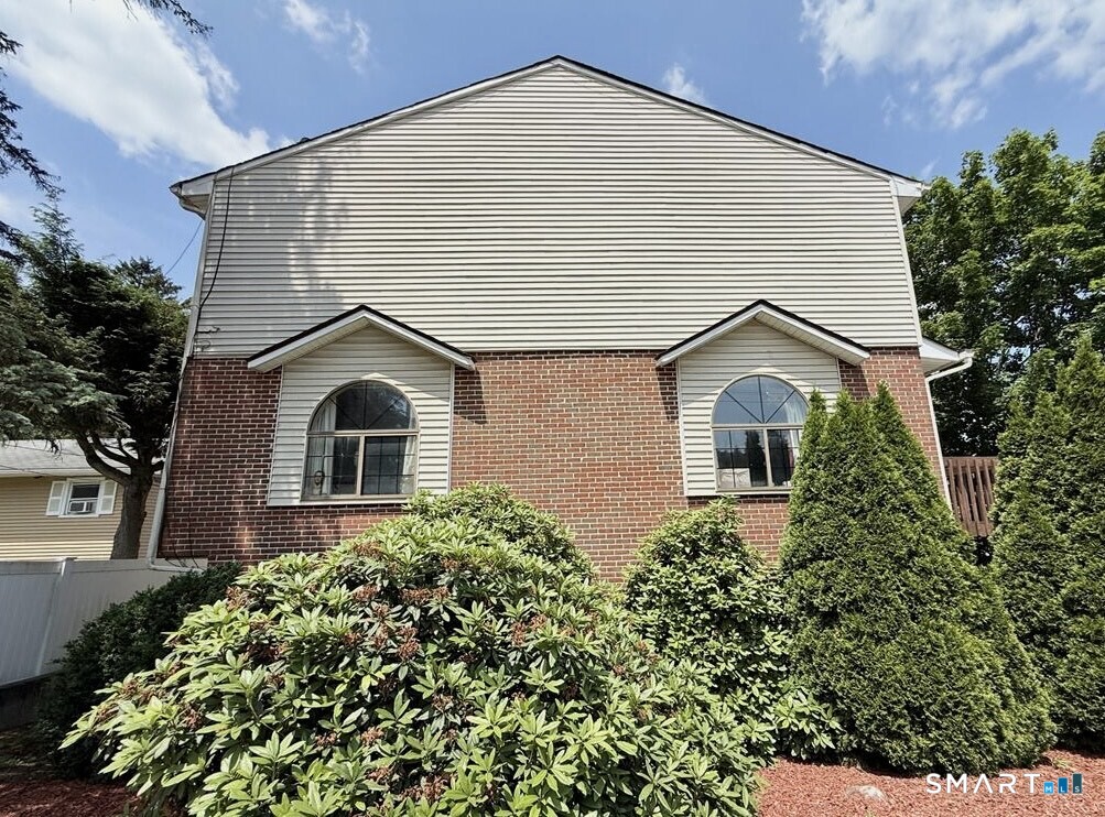 817 Woodtick Road, Unit A Waterbury, CT 06705 - Photo 15 of 16 a front view of a house with a yard
