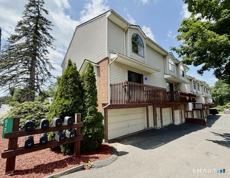 817 Woodtick Road, Unit A Waterbury, CT 06705 - Photo 2 of 16 a front view of a house with a yard